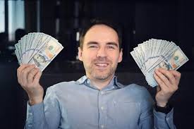 dark background hands holding dollar cash