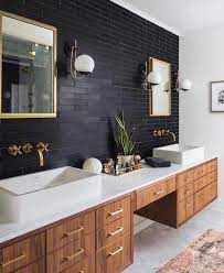 The bathroom vanity here is still made from woods, but colored in darker brown. 9 Ideas For The Space Between Double Sinks In The Bathroom