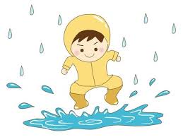 a boy playing in the rainy season puddle