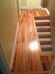 laying hardwood in hallway and into