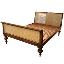 wooden sleigh bed with cane detail in