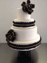 Decorated with layers of sugar tassels, edible gold sugar beads, gold geometric patterns, a gathered fabric detail with edible brooch and topped off with black ostrich feathers and gold beaded decorations. Great Gatsby Themed Wedding Cake Cakecentral Com