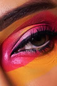 face with a pink and yellow eye makeup