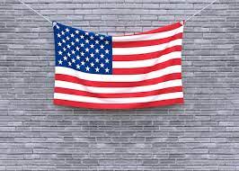 American Flag Hanging On Brick Wall