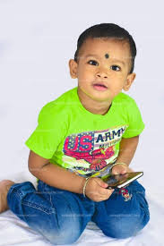 smart indian baby boy with a phone