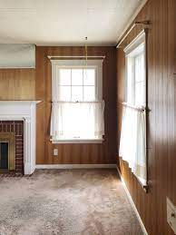 see this dated wood paneled living room