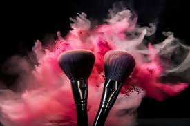 a pink and red makeup brush set with a