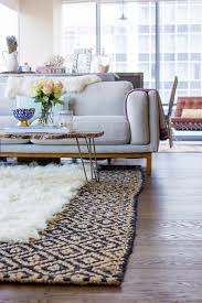 Layered area rugs living room. How To Layer Rugs Like A Pro The Fox She