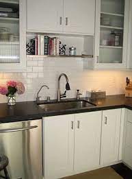Cabinets over the sink hang between 24 and 36 inches above the counter, freeing up overhead space in this area. Kiley Offenstein S Image Kitchen Sink Decor Above Kitchen Sink Above The Kitchen Sink