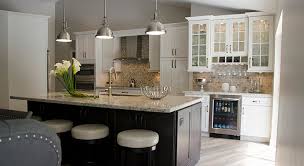 Black pendant lights over the white central island create a focal point. Kitchen Designs With Off White Cabinets