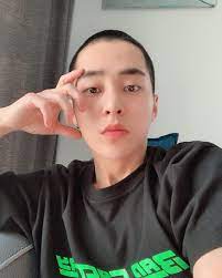 xiumin of exo reveals shaved head ahead