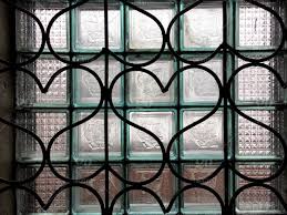 A Wall Made Of Glass Cubes And An Iron Bars Heart Shaped