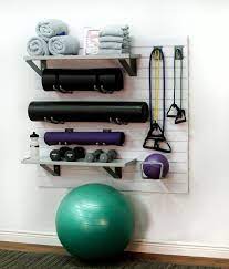 Separate storage use storage bins or a cabinet with multiple nooks to keep all your gear organized, but in plain sight. The Storewall Home Fitness Equipment Storage Kit Helps You Create Your Own Home Gym Oasis Hold Yoga Mats Free We Gym Room At Home At Home Gym Home Gym Design
