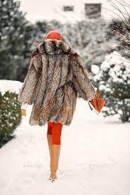 Elegant Woman In A Fur Coat Posing