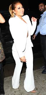 Adrienne Bailon goes braless in white two piece suit on LA night.