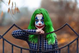 greenhaired woman in joker makeup and