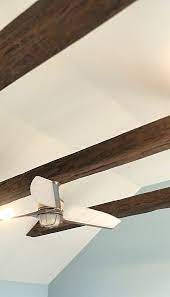 a ceiling fan from suspended faux beams