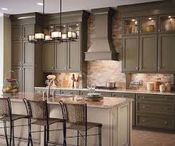 Transitional style is a blend of both traditional and contemporary and often features clean lines and a palette of warm neutrals. A Bright Approach To Kitchen Lighting Kraftmaid Kitchens Traditional Kitchen Cabinets Kitchen Remodel