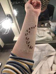 Shark bite scar tattoo