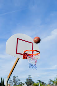 a basketball about to enter a bball net