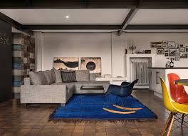 grey sofa on blue rug in open plan