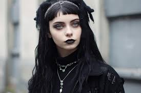 a woman with black hair and black makeup