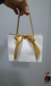 white paper gift bags with gold ribbon