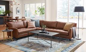 Living room the 8 x 10 nomad vado area rug anchors a small sofa and two chairs, with the front legs of each furniture piece placed on the area rug. How To Choose The Right Size Rug
