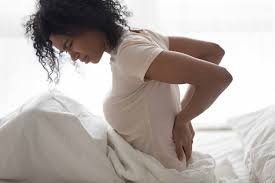what causes postpartum back pain and