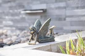 bronze effect laying fairy statue