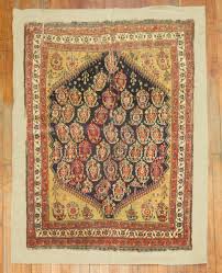 antique qashqai rug sched on linen