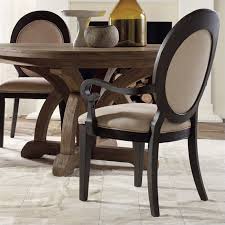 Oval french dining table with french cane round back chairs designed with floral wallpaper and elegant decor in a french dining room. Hooker Furniture Corsica Upholstered Oval Back Arm Dining Chair In Dark Wood 5280 75402