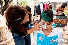 female makeup artist putting makeup on