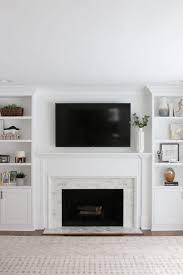 a white marble tile fireplace update