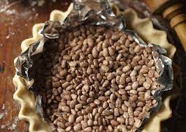 In this method, a barrier (like parchment paper or tin foil) is placed over the soft dough and filled with about a pound and a half of dry, uncooked beans of some sort. How To Pre Bake Blind Bake A Pie Crust Allrecipes