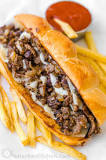What is typically on a Philly cheesesteak?