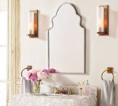 Pottery barn vintage fixed mirror in a powder room above a single white washstand topped with gray marble and a pottery barn brass faucet. Stella Scalloped Frame Mirror Pottery Barn