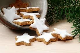 Christmas chocolate chip cookie dough and cookie cutters on a wood surface. How To Make Swiss Christmas Cookies Cinnamon Stars The Local