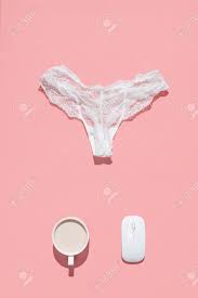 The Concept Of An Erotic Chat Worker. White Lace Panties, Wireless Mouse  And Cup Of Coffee On A Pink Background Stock Photo, Picture and Royalty  Free Image. Image 140618621.