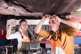 Handsome Mechanic And Beautiful Female Assistant Working At A