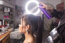 makeup artist spraying hairspray