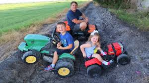 playing in the mud with kids tractors