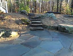 Large Stone Patio With Rustic Stairs In