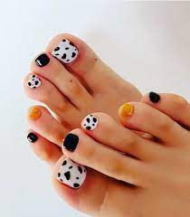 cow print black and gold toe nails