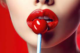 red lips and a lollipop in her mouth
