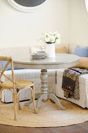 The round dining table highlights the curved lines of the fixture. How To Decorate With A Round Rug