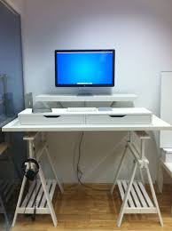 The top measures roughly 72x40 and the desk adjusts from 28 tall up to 48 tall with a hand crank that is hidden under the top of the desk and pops out to adjust the height. 10 Ikea Standing Desk Hacks With Ergonomic Appeal Diy Standing Desk Ikea Standing Desk Desk Hacks