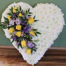 Heart shaped standing arrangements are a great way to show grief over loss of loved ones and friends. Send White Chrysanthemum Based Heart Funeral Flower Tributes To Sussex