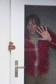 Man Opening Door And Looking Through