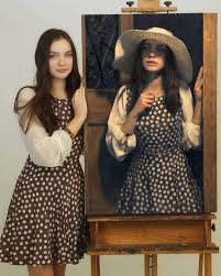 models stand next to paintings of